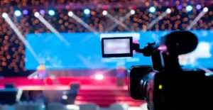 Camera focused on a stage with vibrant bokeh lights.